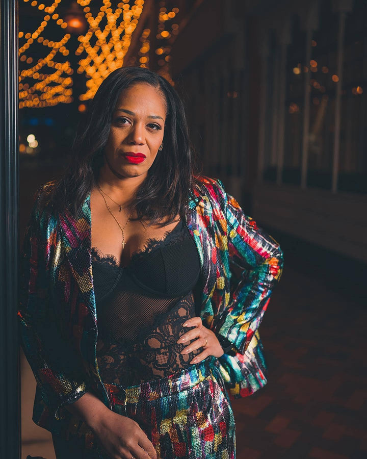 woman leaning with open plus size sequin suit jacket