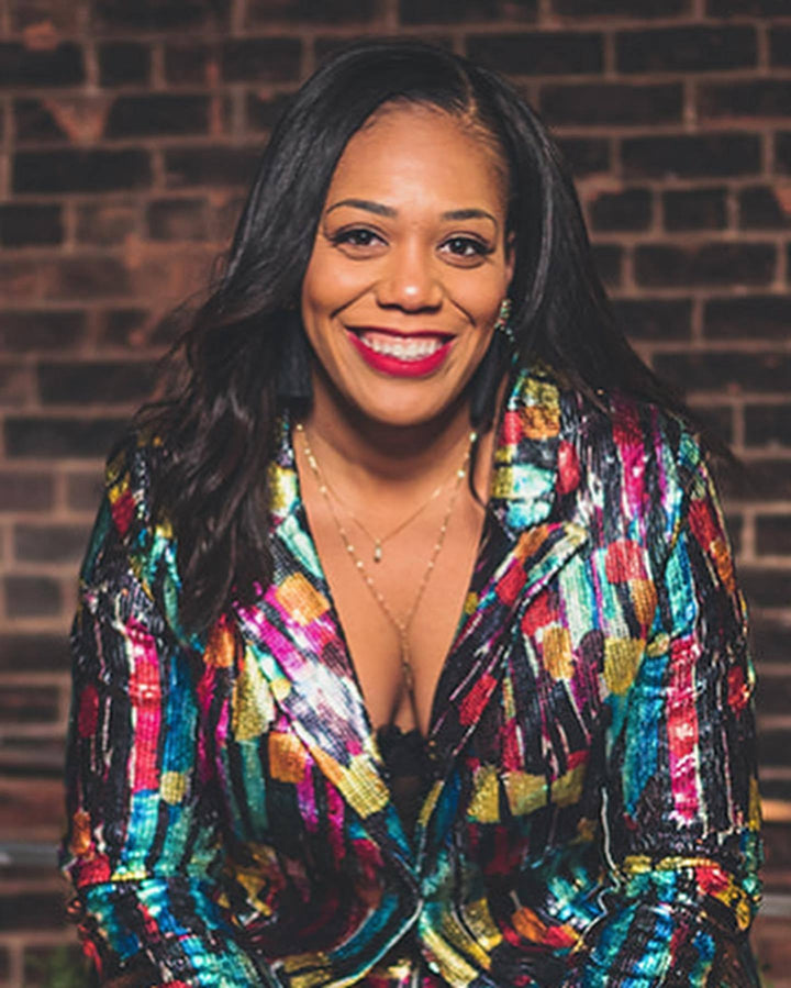 smiling woman on plus size sequin suit
